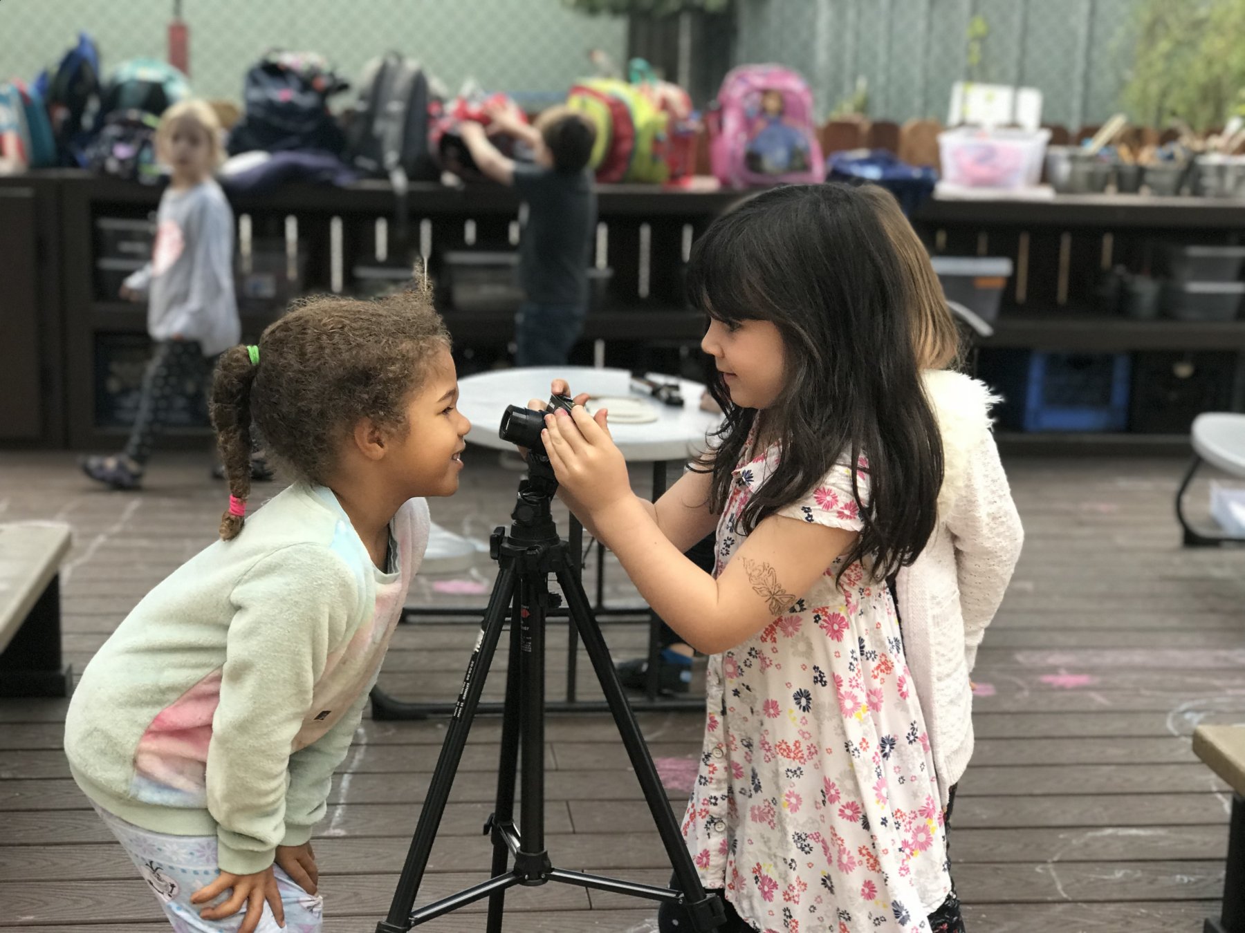 Preschool girls play with camera