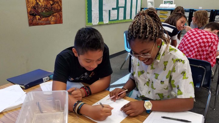 MS Students smile in science classroom lab partners