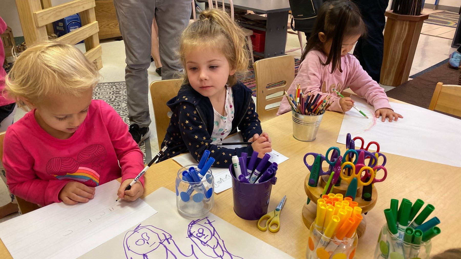 Preschool students write and draw