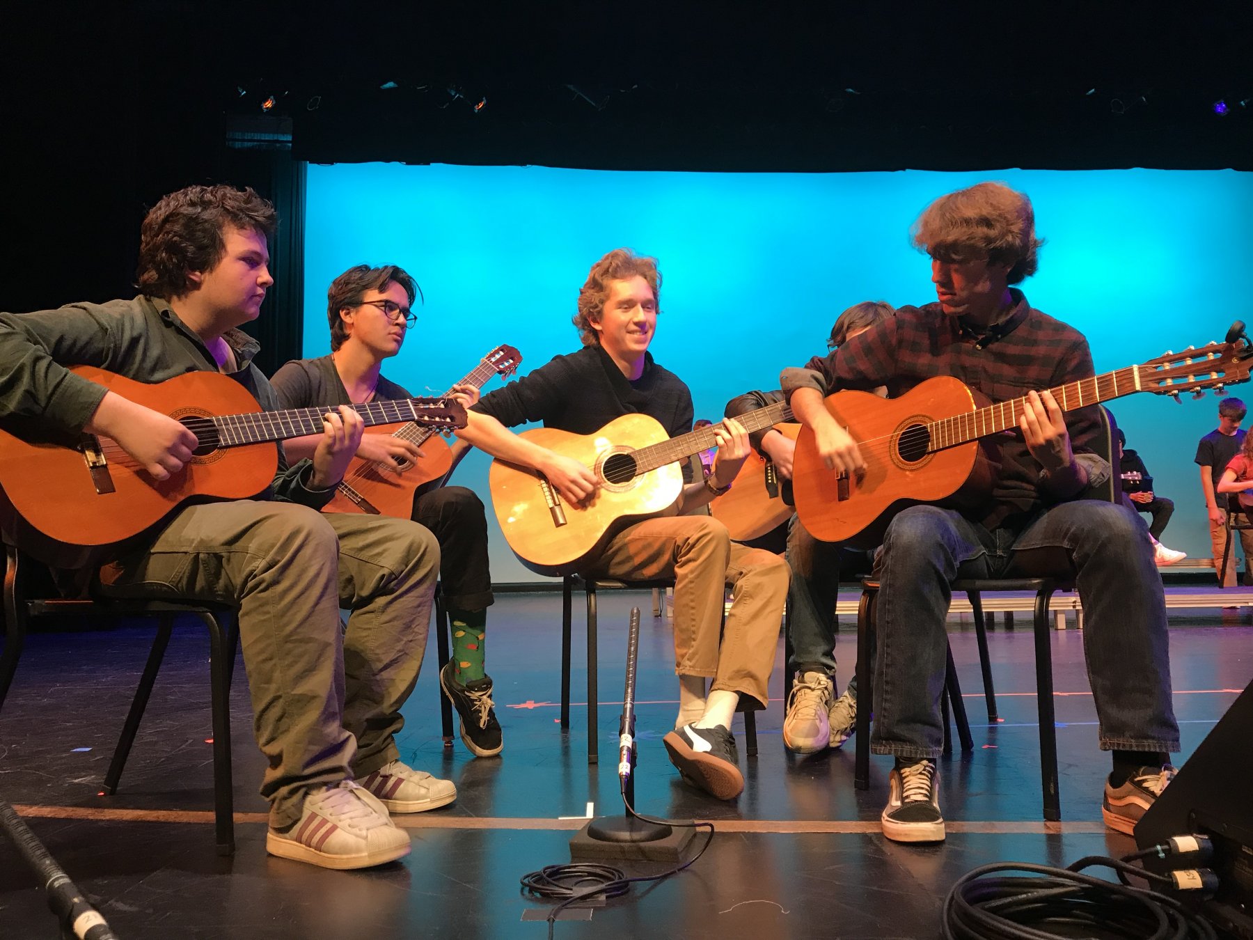 HS Boys play guitar on stage